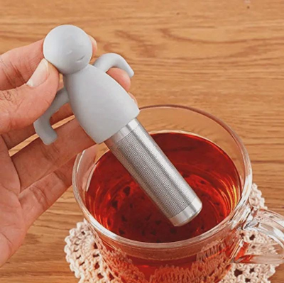 Loose leaf tea infuser with stainless steel tea ball and fresh tea leaves